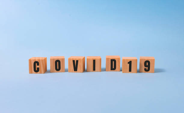 istock Covid 19 word on wooden cubes, covid concept 1284132729