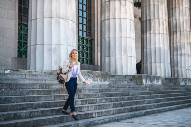 istock Smiling Blonde Law Student with Backpack Departing Building 1284133589