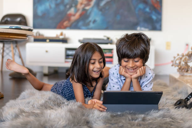 istock Elementary age siblings of Indian descent having video virtual playdate with friends 1284133778