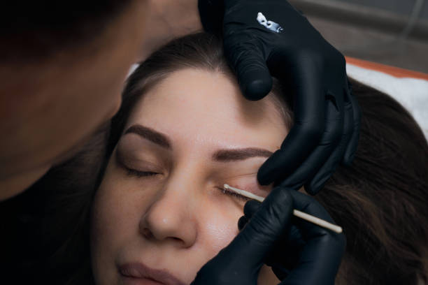 istock Permanent eyebrow makeup procedure. Eyebrow tattooing, process. The use of tools by a master for permanent eyebrow makeup. 1284133906