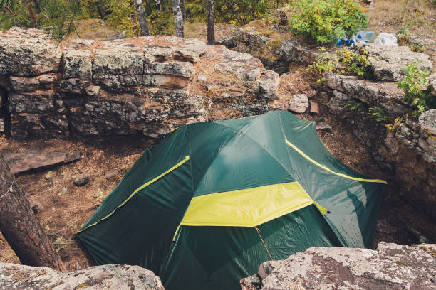 istock Tourist tent in forest camp among meadow. 1284134240