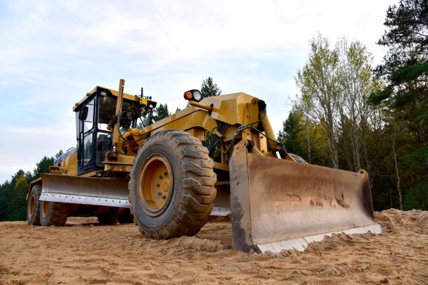 istock Motor Grader on road construction in forest area 1284137031