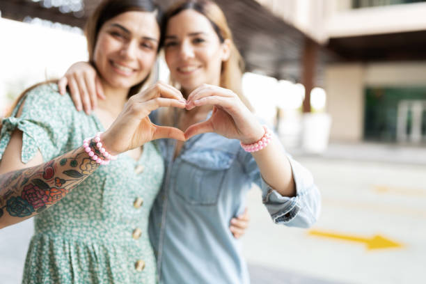 istock Young women shaping their hands into hearts 1284137814