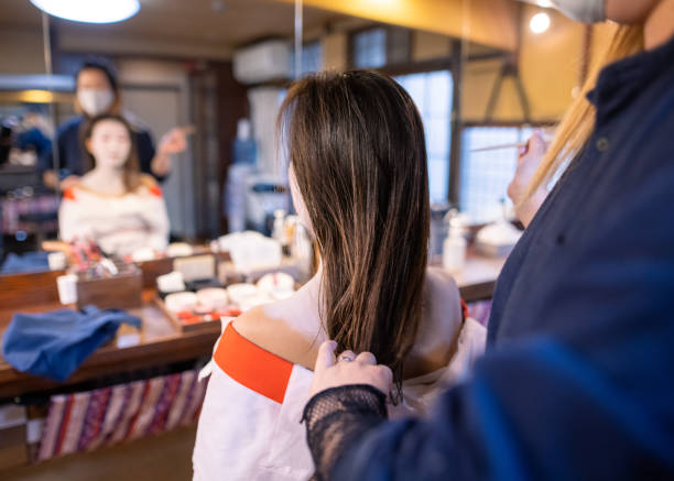 istock Young woman getting special white face makeup for Maiko makeover experience 1284138546