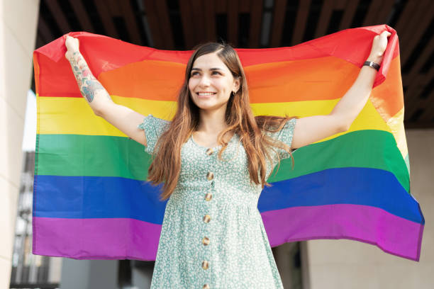 istock Hispanic young women holding a rainbow flag 1284138589