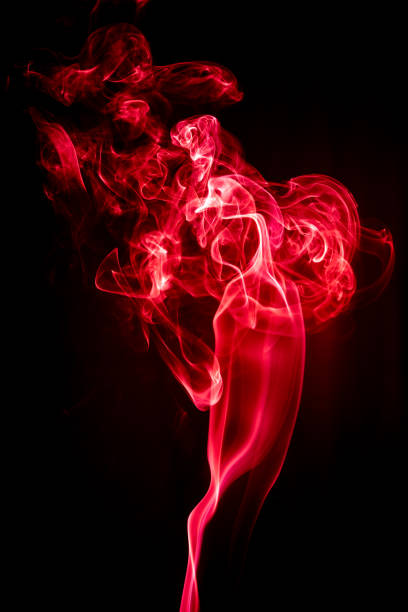 istock Red abstract shaped smoke against black background. Abstract background 1284138740