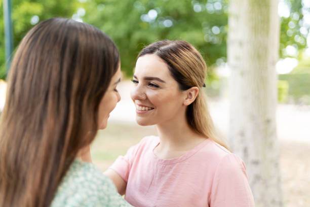 istock Happy young woman looking at her girlfriend 1284139565