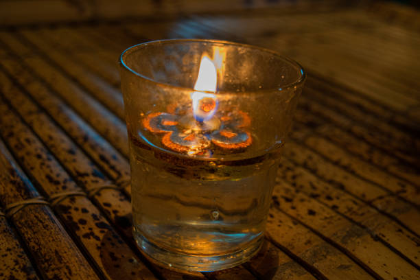 istock Worm candelar on wood table background, scene from Bali, Indonesia 1284139774