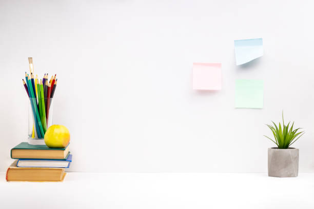 istock side view for a study desk with stationery, books and colored pencils on it. studio shot. background backdrop 1284141366