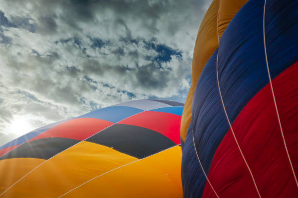istock two multicolored balloons against cloudy skies 1284146373