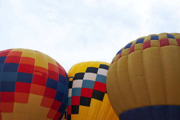 istock three colored balloons against the cloudy sky 1284146383
