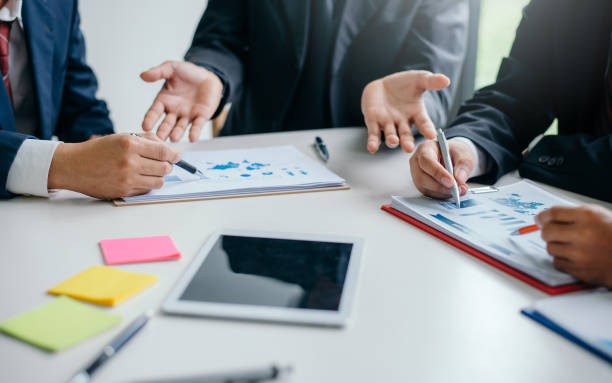 istock Businessman pointing to a document graph during a business meeting. 1284152455