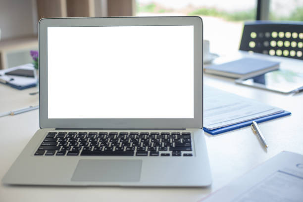 istock Mock up. Laptop and computer white screen on the table in the office or meeting room. 1284153034