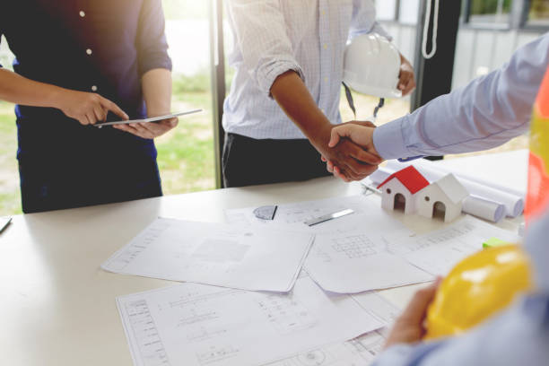 investor and engineer shaking hands at meeting. - corporate business manager manual worker architect imagens e fotografias de stock