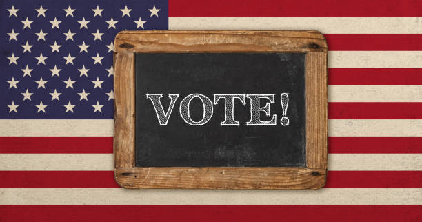 istock Vote Old designed vintage american flag blackboard 1284154098
