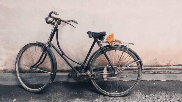 istock An old bicycle was propped against a gray wall 1284157922
