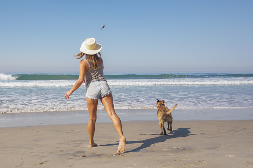 Woman and her dog at the beach