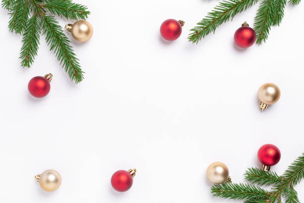 istock Minimal christmas composition. Fir tree branches with red and gold christmas balls on white background. Top view. Copy space 1284164770