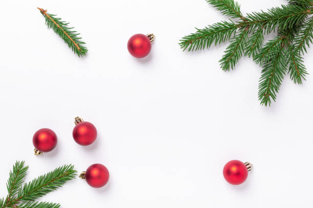 istock Minimal christmas composition. Fir tree branches with red christmas balls on white background. Top view. Copy space 1284164774