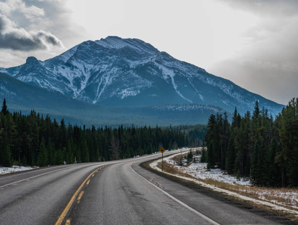 istock Single Lane Highway in Winter in Kananaskis, Alberta 1284167725