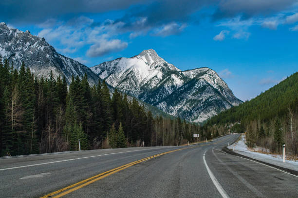 istock Single Lane Highway in Winter in Kananaskis, Alberta 1284169605