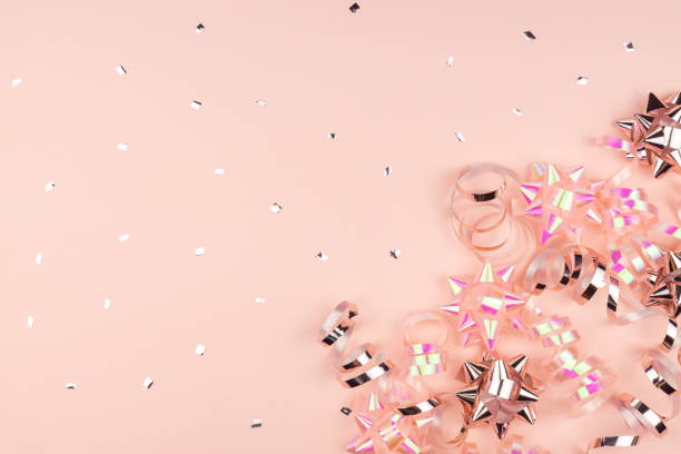 istock Christmas or New Year composition with pink sparkling ribbons and gift bows decorations on pink background. Flat lay and copy space 1284169775