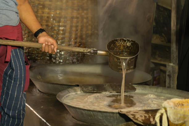 istock Asian man making boiled palm coconut sugar or cane production process, raw material, Amphawa, Thailand. Traditional culture lifestyle. Local sweet food. 1284171824