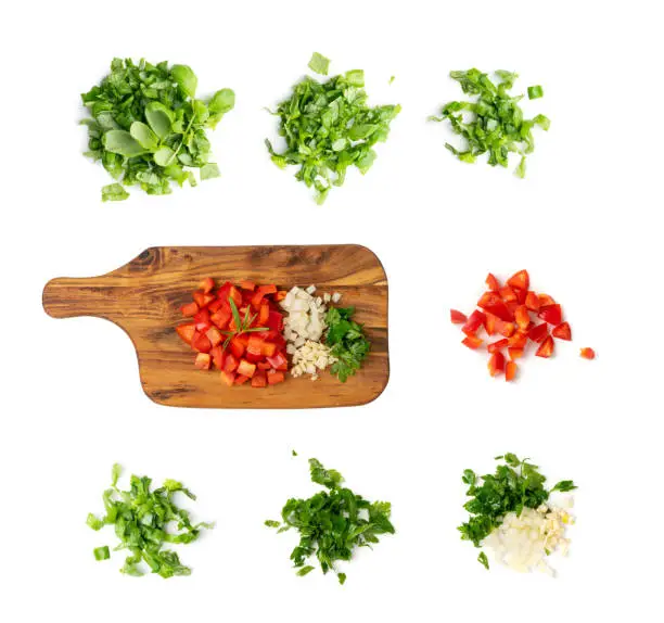 Photo of Chopped paprika or red sweet pepper cuts on wooden background