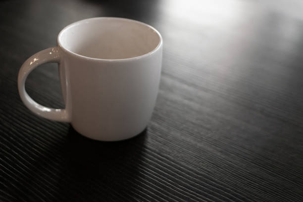 istock Coffee mug and mobile phone on the table closeup 1284173753