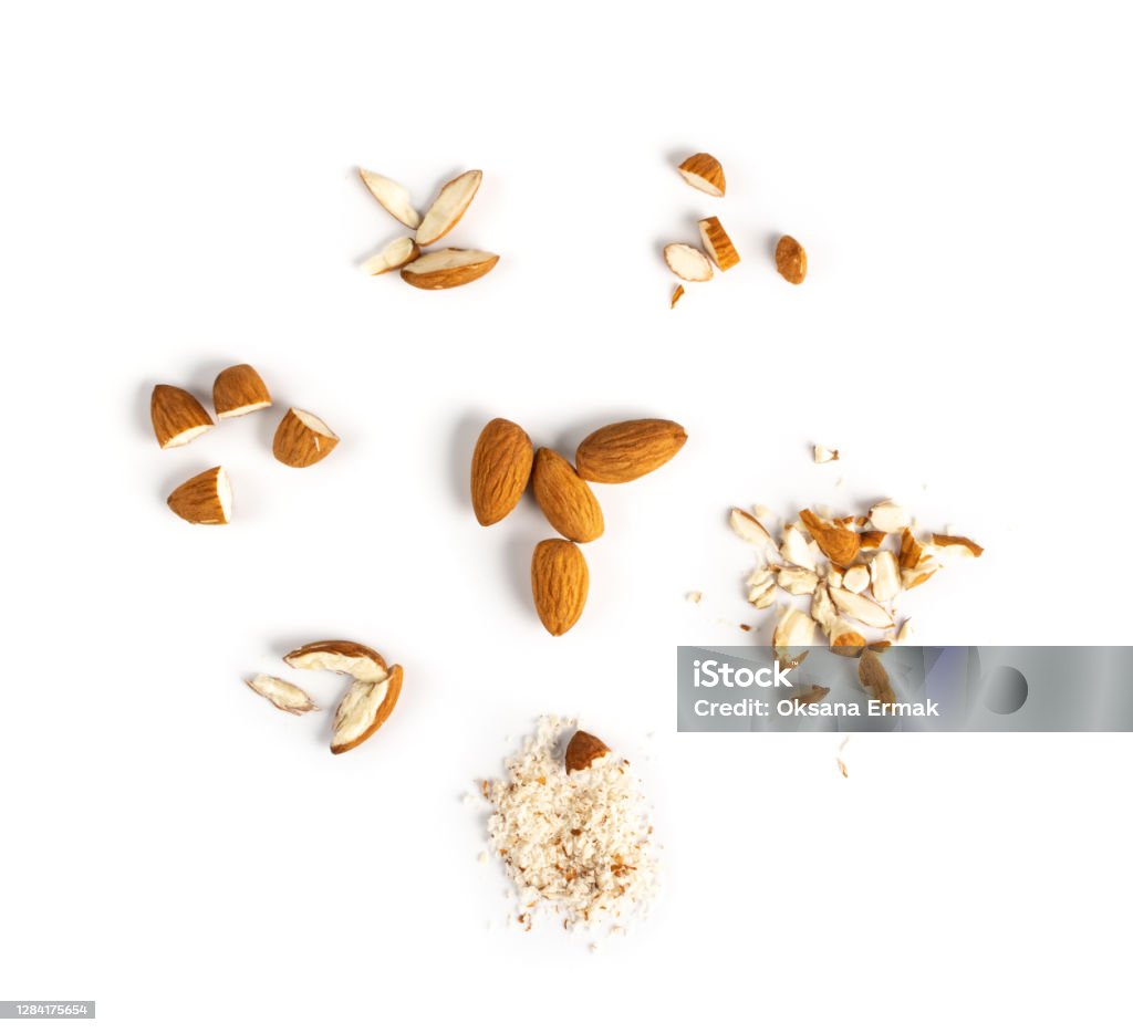 Crushed Almonds Isolated on White Background Closeup Crushed almonds isolated on white background closeup. Grated almond seeds and cut kernels collection Almond Stock Photo