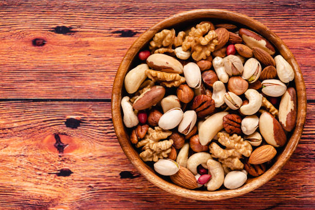 istock Various Nuts in wooden bowls 1284175930