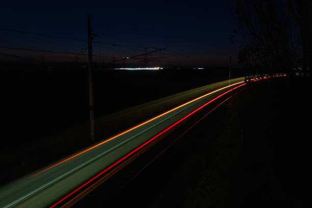 istock Train back light colorful trails on rails. Travel at night, long exposure 1284176890