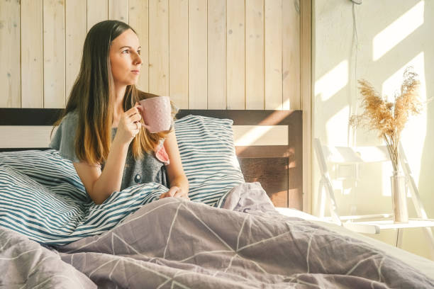 istock Woman with morning coffee in bed. 1284178665