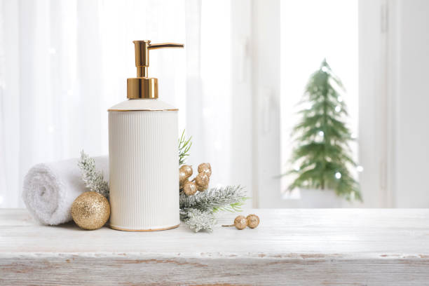 Spa concept with soap dispenser, white towel and Christmas ornaments