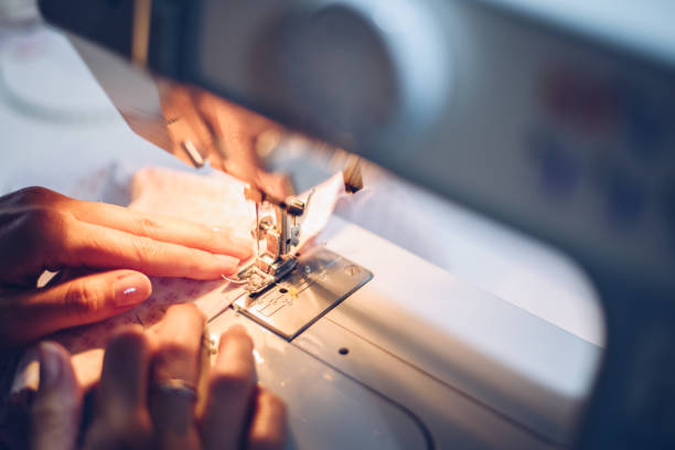 istock A young long-haired woman sews with her machine 1284181903