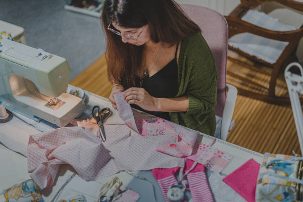 istock Long-haired young woman makes a rag doll 1284181965