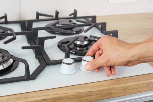 istock Male hand set temperature on control panel of hob 1284183089