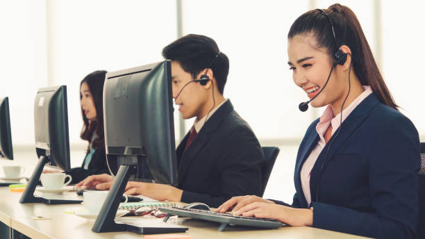 istock Business people wearing headset working in office 1284183564