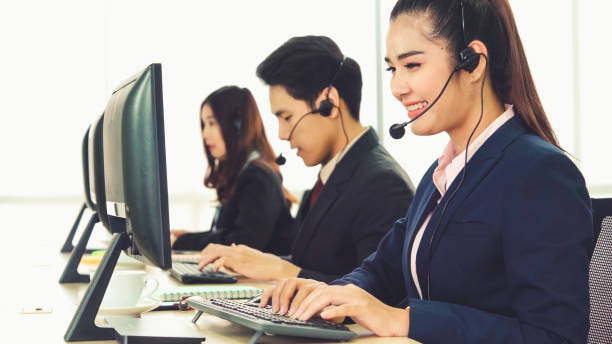 istock Business people wearing headset working in office 1284184640
