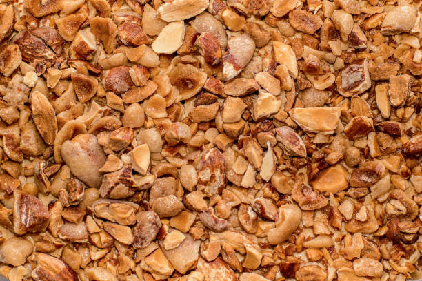 istock Crushed sugar-coated candied caramelized almonds background 1284184642