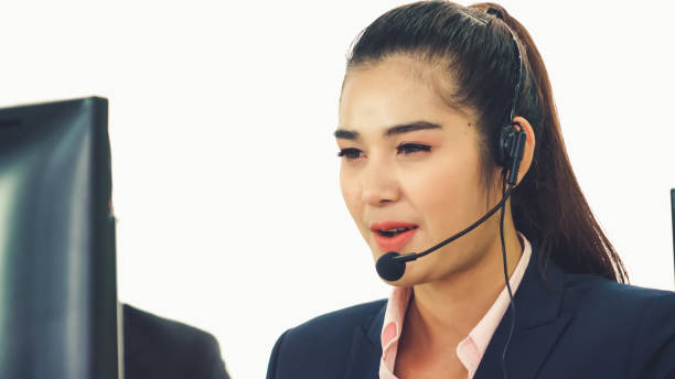 istock Business people wearing headset working in office 1284184662
