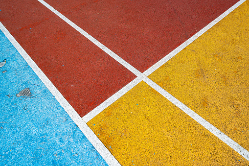 Basketball court half-court line and red center circle with rubber granules on the playground