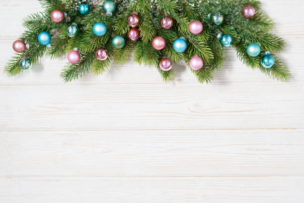 istock Christmas tree branches with pink and bluew decoration balls flat lay frame with copy space 1284185685