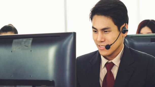 istock Business people wearing headset working in office 1284186400