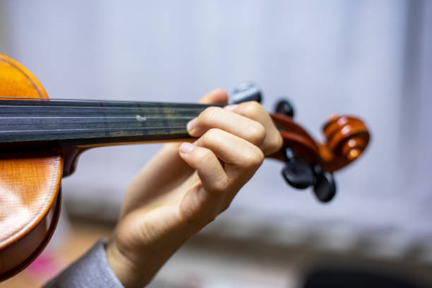 istock hands of a little violinist while playing the violin, staging the hands 1284186965