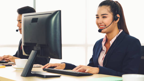 istock Business people wearing headset working in office 1284188652