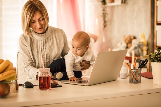 istock Mother working from home while carrying for her baby girl 1284190232