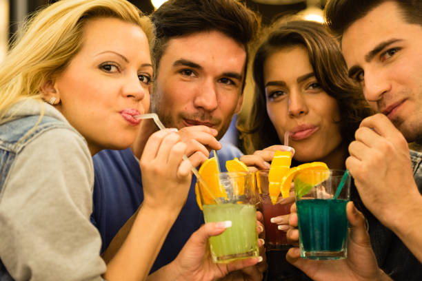 istock Four friends taking a picture with their colorful drinks 1284190420