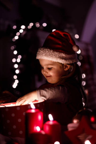 istock Curious girl discovering Christmas gift 1284190817