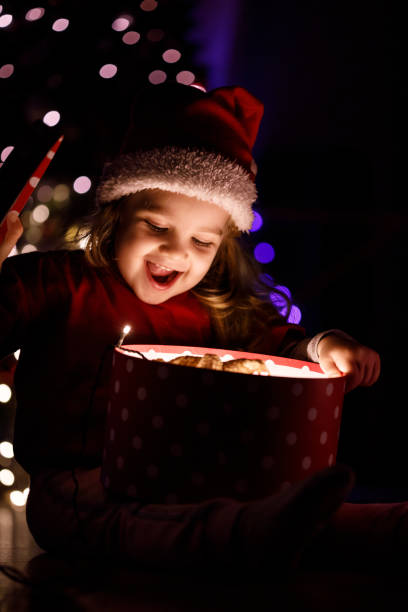 istock Surprise moment for a little girl when opening a gift 1284190848